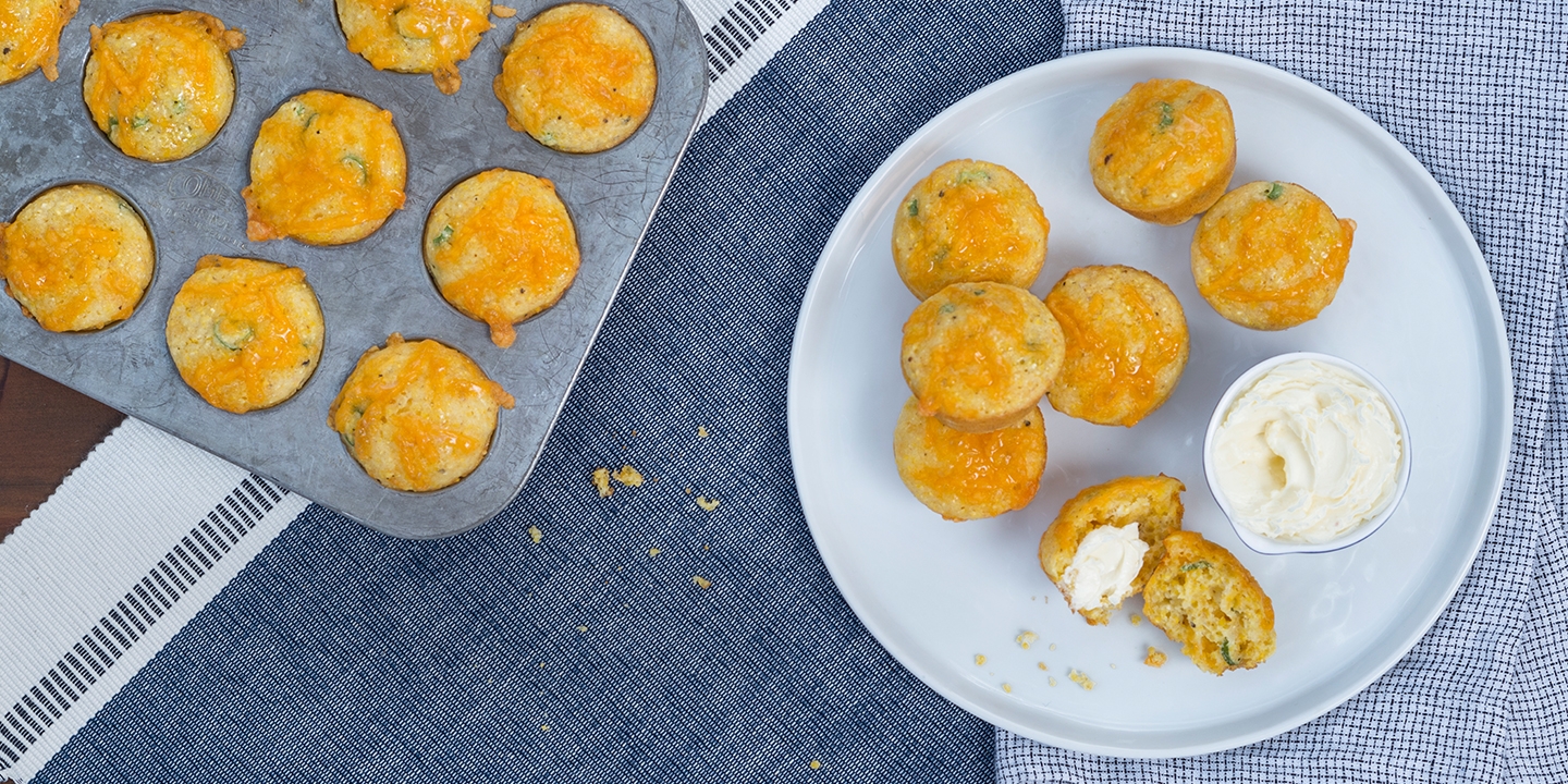 Cornbread muffins in a baking pan and served on a plate