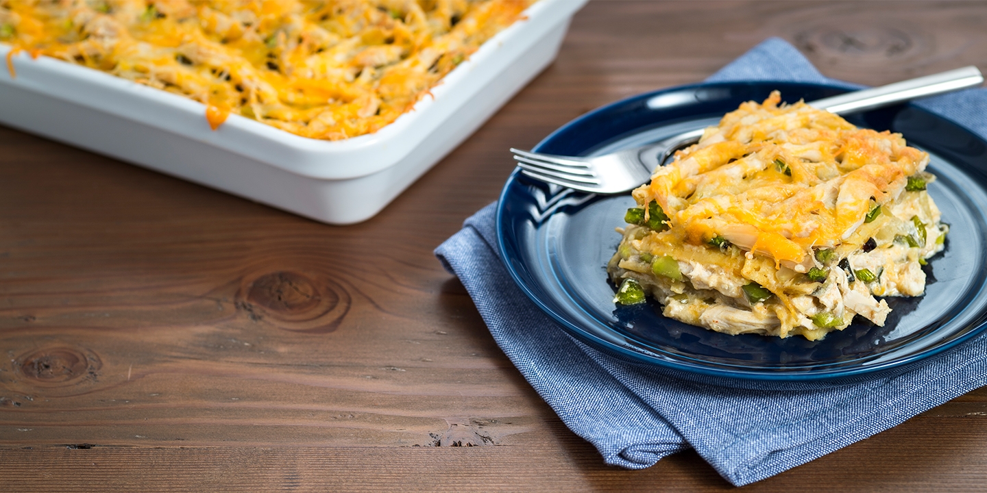 Roasted Tomatillo and Chicken Enchilada Cassarole served on a blue plate