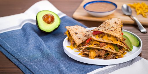 Ranch Quesadilla wedges served with a side of avocado on a plate