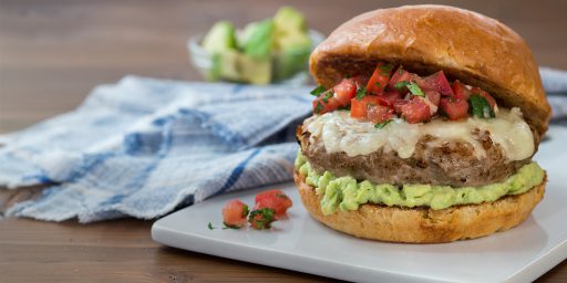 Turkey Cheeseburger with Avocado Spread served on a white board