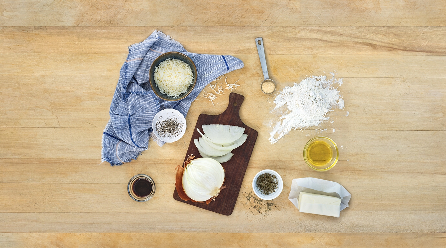 Ingredients for No-Knead Focaccia Bread with Caramelized Onions on a wooden countertop