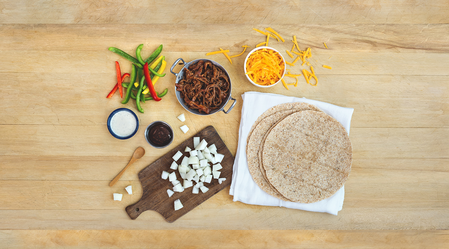 Ingredients for BBQ Ranch Quesadilla Wedges on a wooden countertop