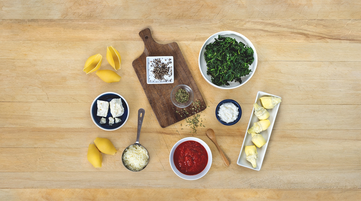 Ingredients for Eight-Cheese Stuffed Shells on a wooden countertop