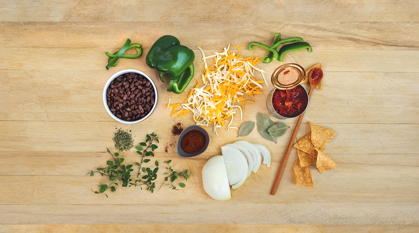 Ingredients for Texas Red Chili Cheese Bowls on a wooden countertop