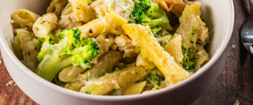 A bowl of baked chicken broccoli alfredo pasta