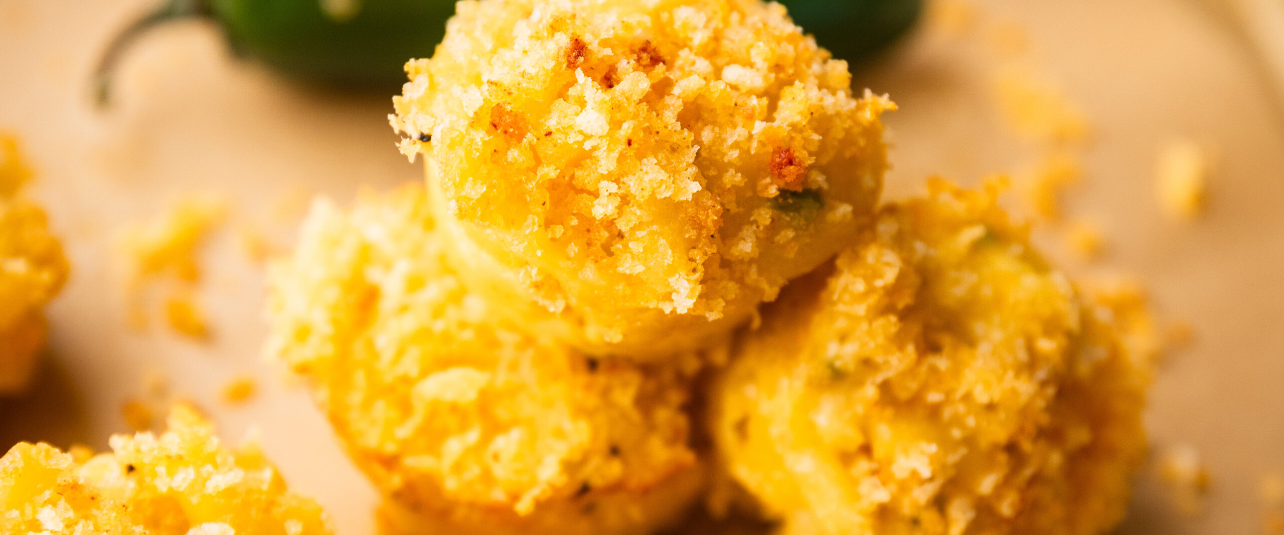 A close-up of baked mac and cheese bites